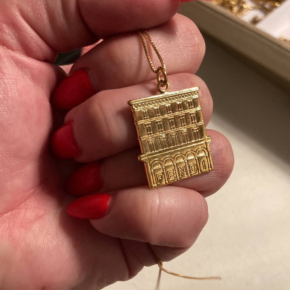 Fendi logo House charm on a necklace in gold